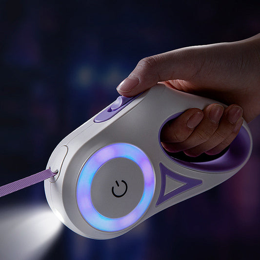 A Hand holding a retractable dog leash with glowing elements against a dark background