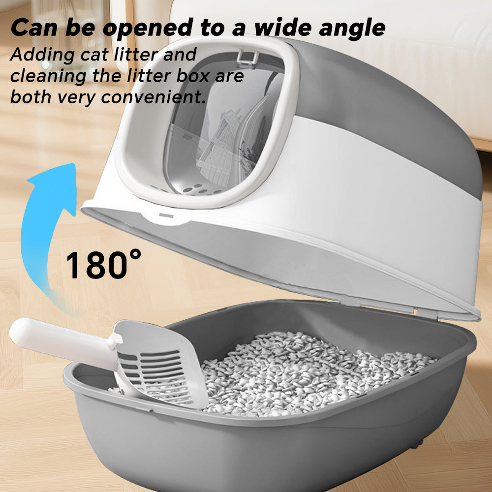 Cat litter box with a scoop on a wooden floor, showing its wide-opening feature.