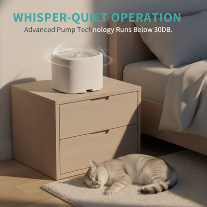 Cat lying on the floor next to a white pet water fountain on a wooden cabinet with 'Whisper-Quiet Operation' text.