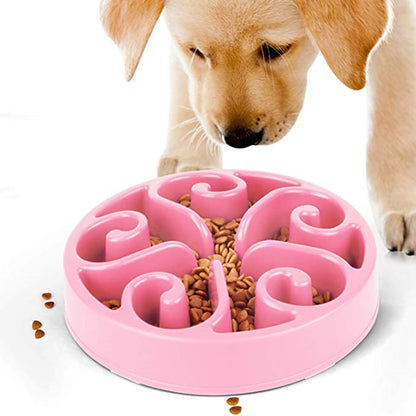Pink slow feeder for dogs with a puppy eating from it